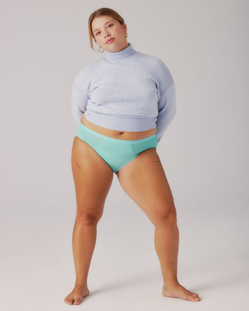 girl wearing turtleneck and blue period underwear