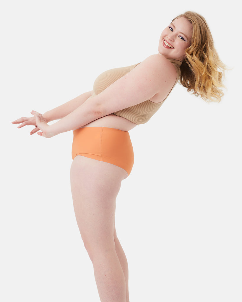 teen wearing orange leakproof period underwear