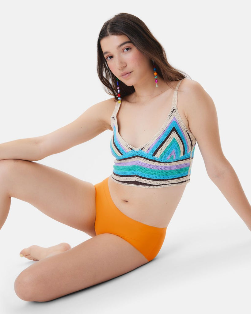 teen sitting wearing orange leakproof underwear